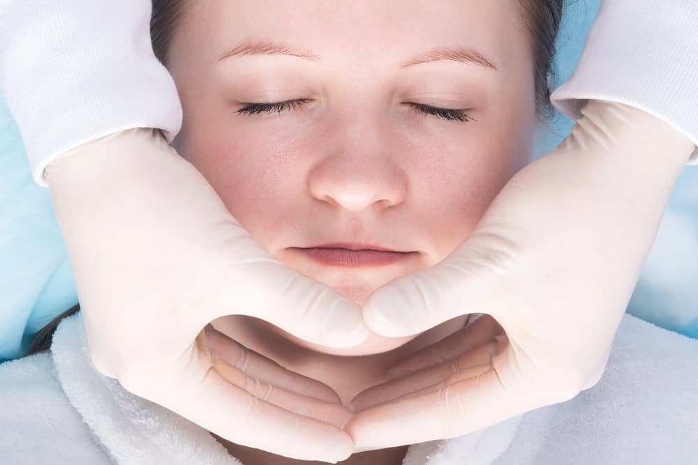 TMJ treatment Close-up image of a facial massage session, featuring Sleep Better Columbus and highlighting TMJ treatment to visually represent noninvasive therapy options for jaw pain relief.<br />
